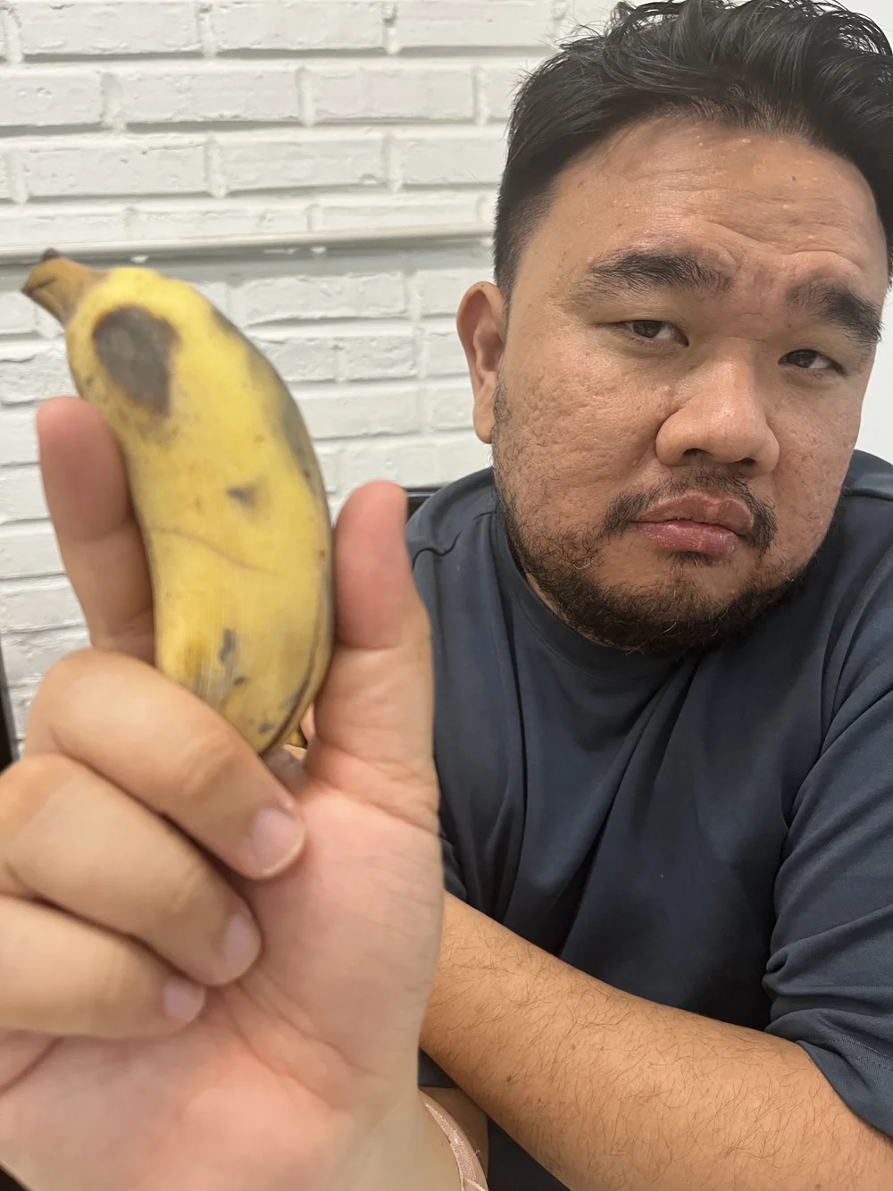  Tam holding one of the five bananas I ate for dessert.  