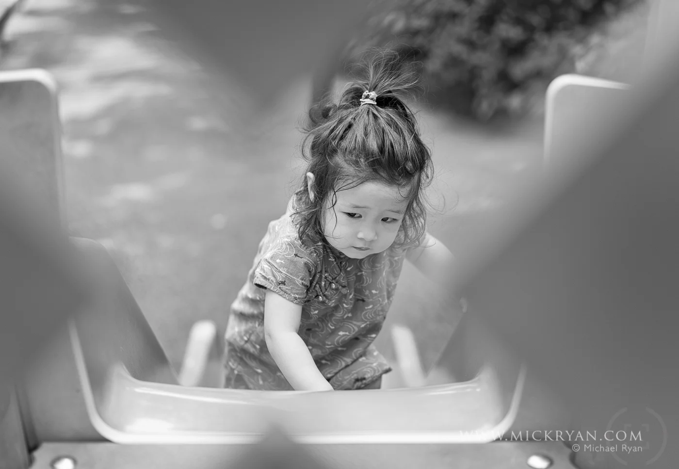 I love the determination on her face here. She is going to get to the top of that slide. Never mind that she is going the wrong way.