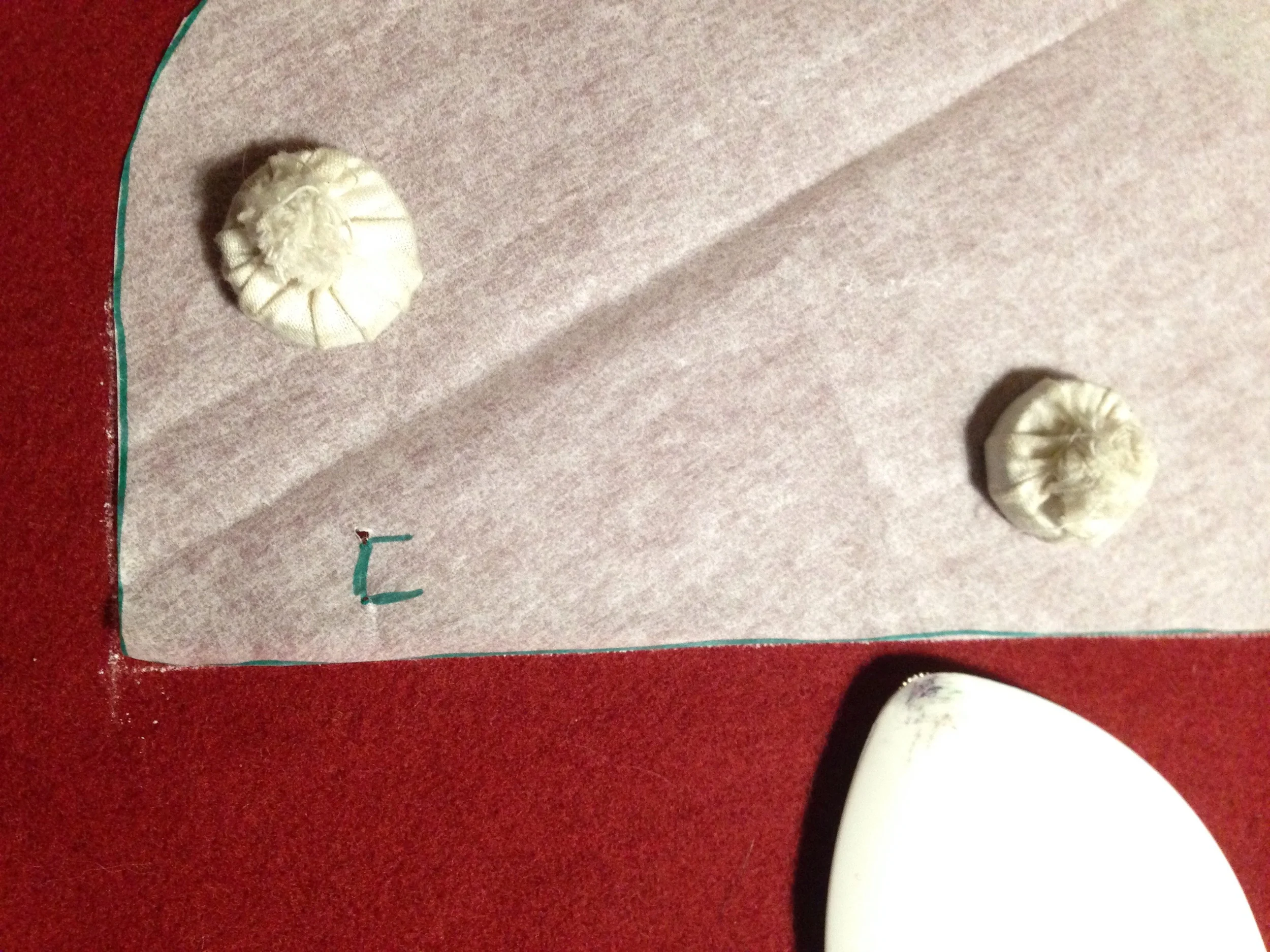 Here I'm using simple pattern weights made out of stacks of pennies and foreign coins wrapped in muslin. Large washers and paperweights also work well.