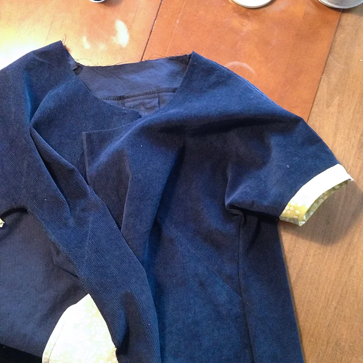 Shoulder seams and one side seam sewn and bias tape is attached to the sleeves.