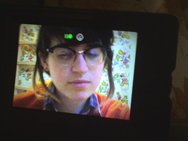 More college earthtone selfies. Here's a clip from a video piece featuring a fantastic orange sweater.