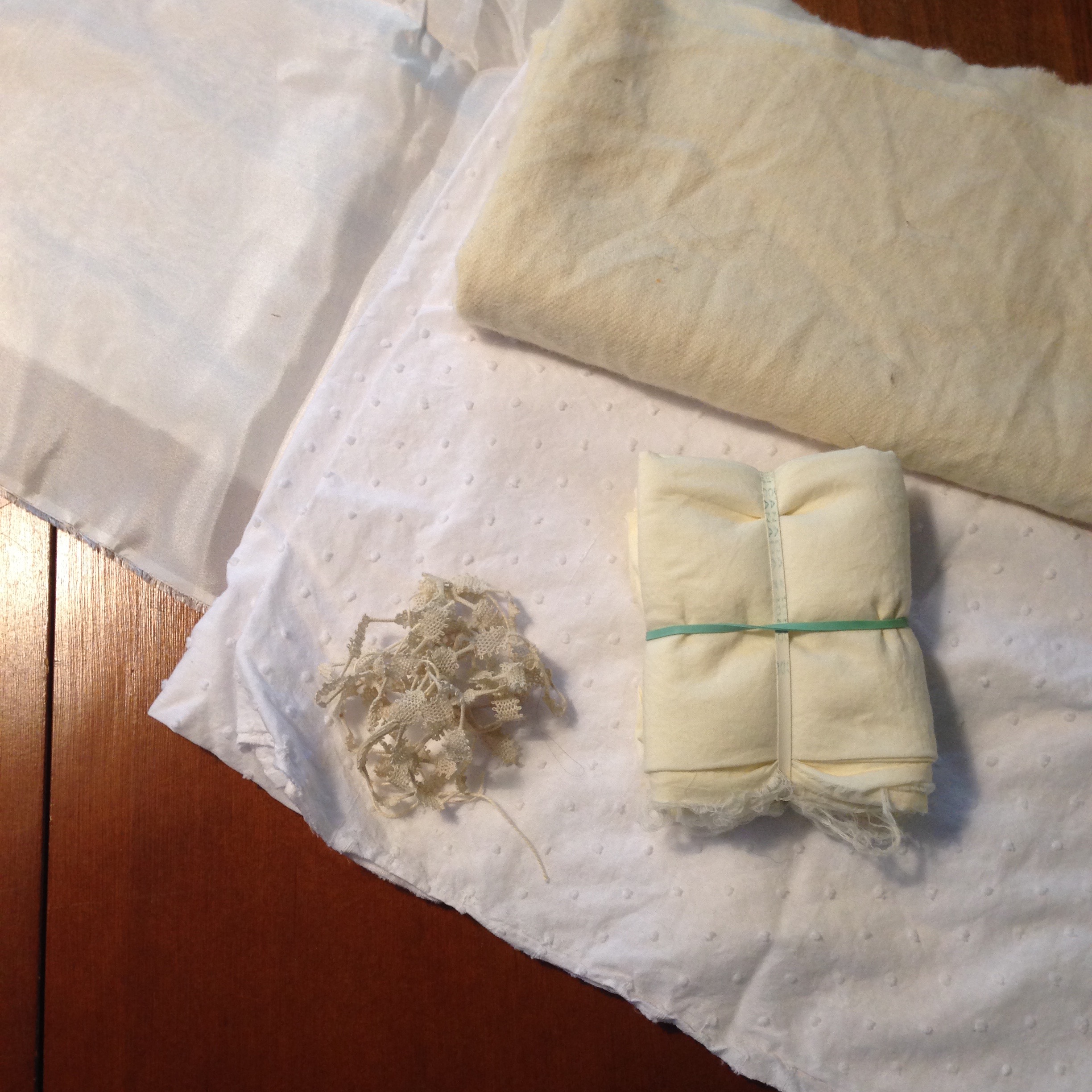 Silk habotai, cotton swiss dot, wool twill, cotton lawn (in the shibori bundle), and cotton lace.