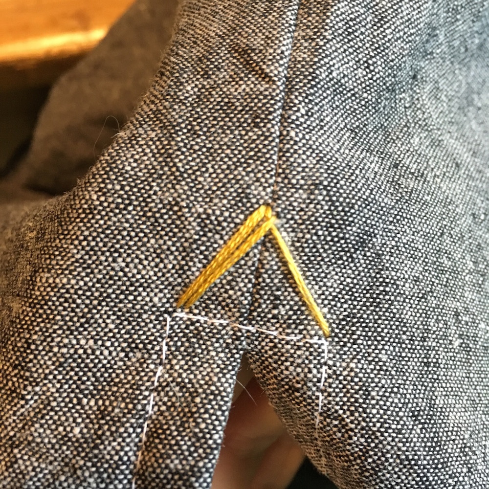 Next, come back up through the fabric just to the right and below the top point. Then, go back down next to the last stitch sewn on the left side, so that your two strands on the left are side by side.