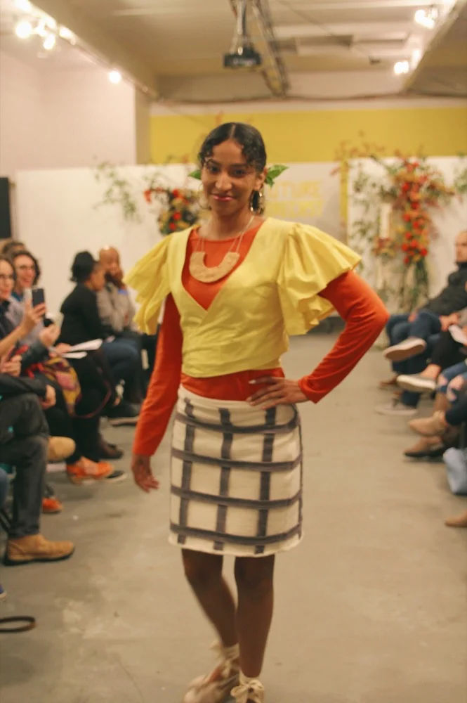 Dariana wears a cotton terry skirt with a check pattern made from fabric scraps and a handmade felt necklace. The yellow top is by Nathalia JMag (dyed with turmeric) and the long sleeve undershirt is secondhand.