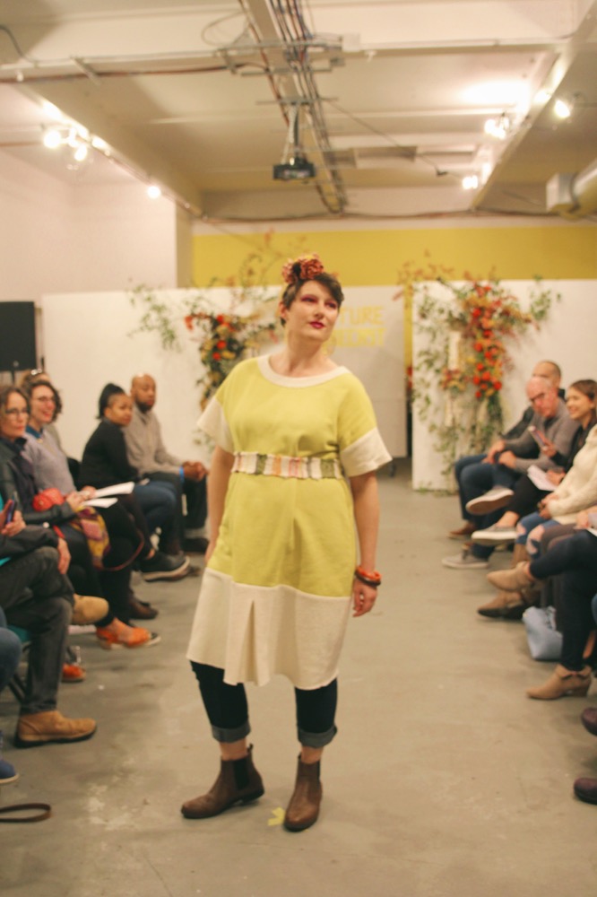 Sarah wears a weld dyed terry dress with reverse terry accents and a ‘rag rug’ woven belt. The jeans are her own, handmade by the model herself! Her earrings are by Peston.