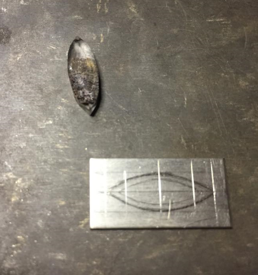  Tracing the base of the setting onto 14k white gold sheet before cutting out.