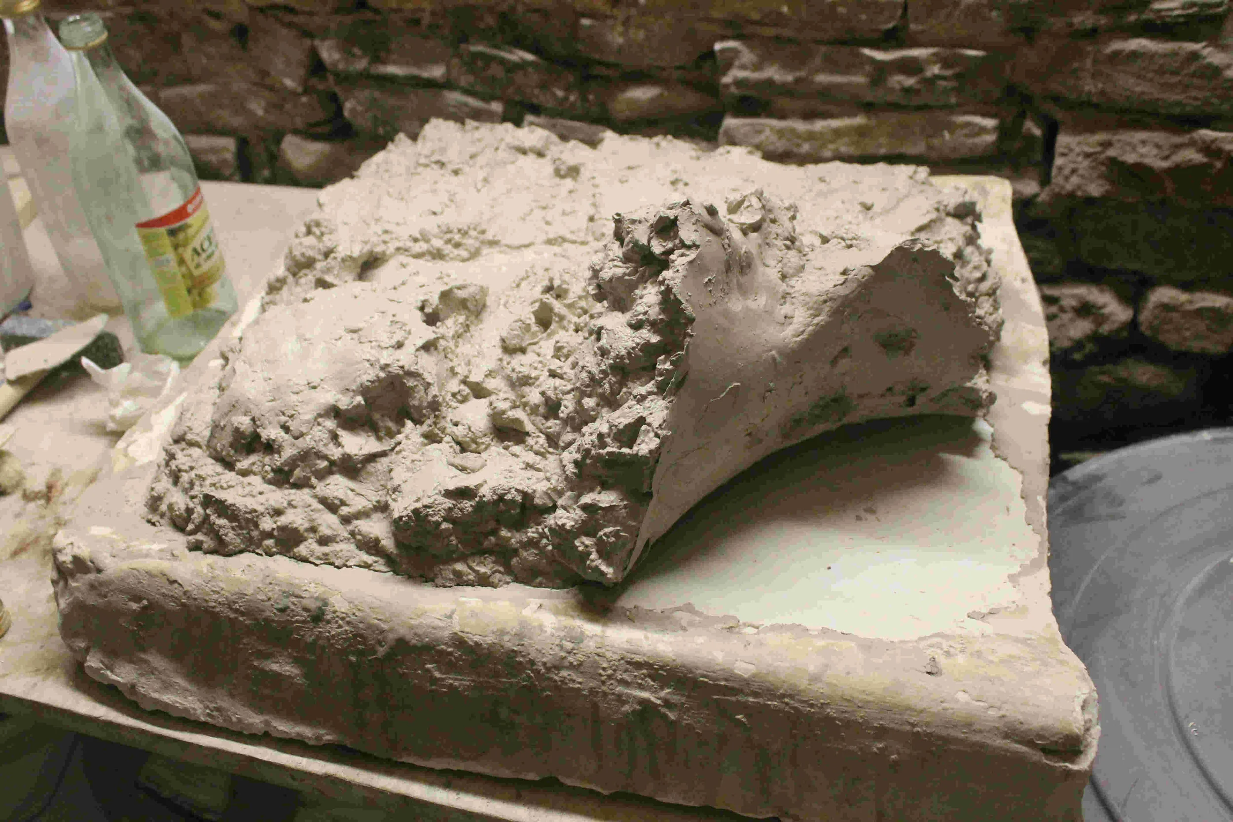 Turning the clay.
