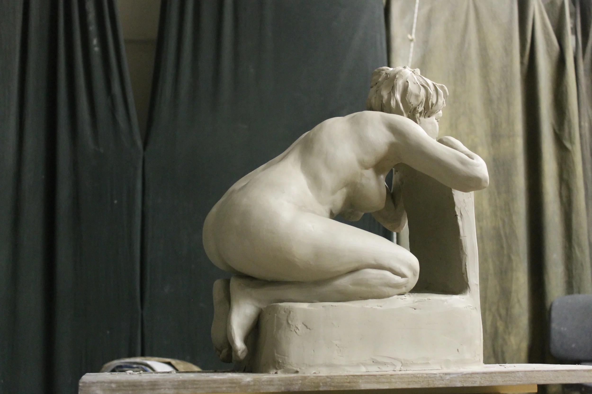 Original clay of crouching figure.