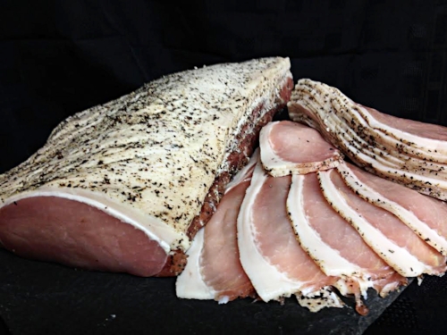 Free range plain back bacon which has been dry cured with juniper and black pepper.