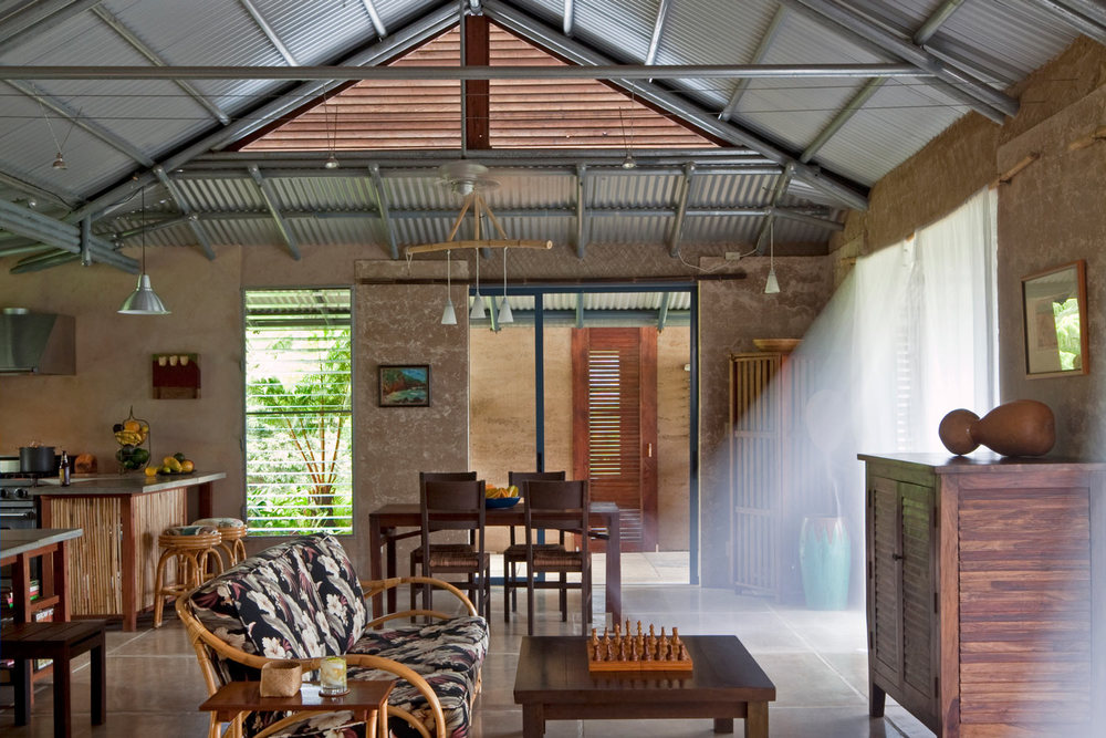  The key to comfort in the tropics is ventilation - lots of it. We used supporting earth walls as sparingly as possible. Big panels of sliding glass open to mimic the original concept of a Hawaiian hale. Open gable ends and cupolas keep the air flowi