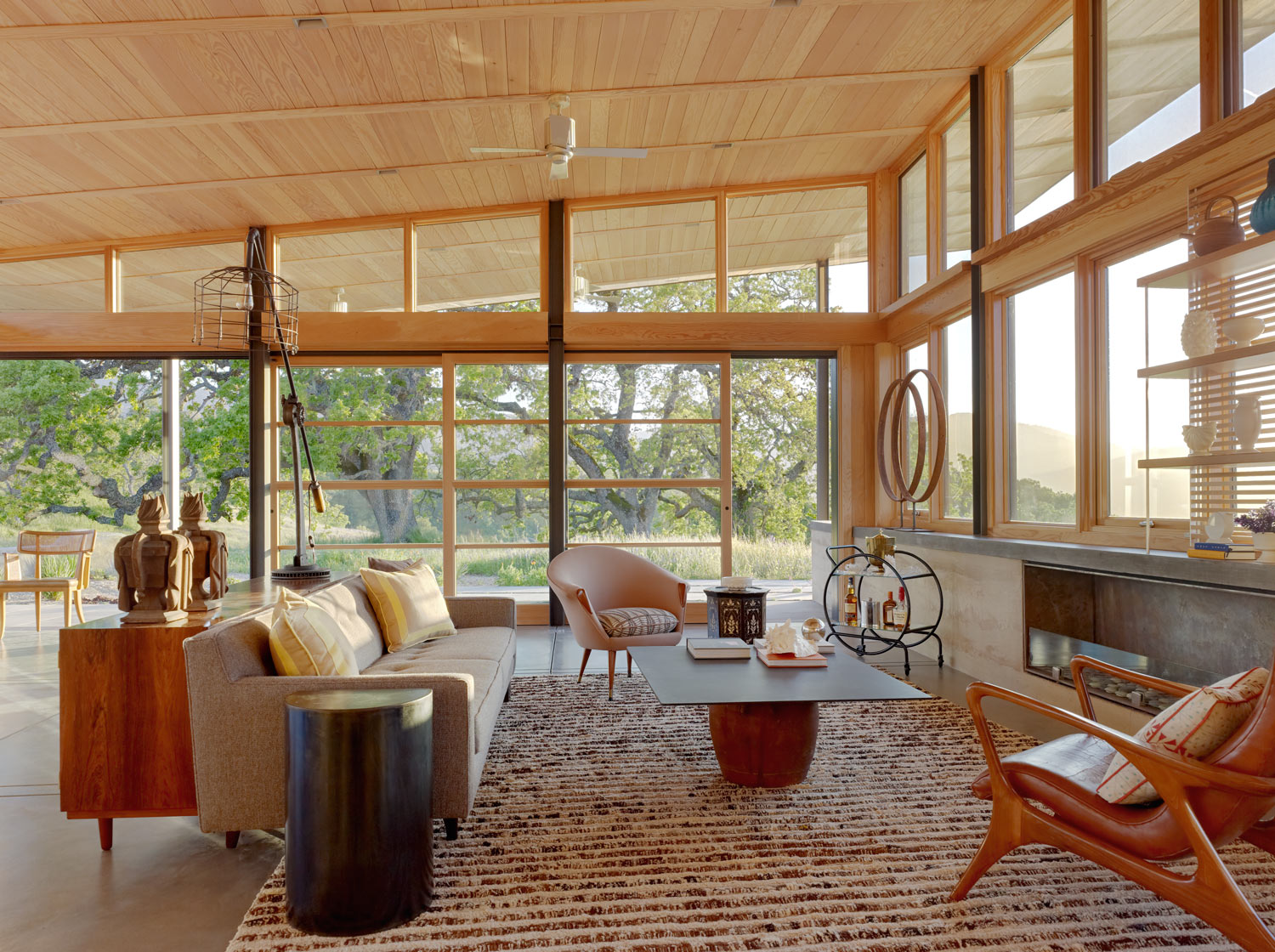 The glazing, natural ventilation and operable shading act as a passive heating and cooling system, cooling the house in the summer and warming the house in winter. Rammed earth walls provide thermal storage. The window vista also puts the occupants right square in the middle of the Preserve - 270 degree views of the flora and fauna of the Carmel Valley. Image © Joe Fletcher