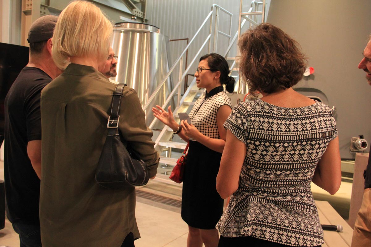 Dr. Rongrong Hu speaking with attendees of her presentation asking them their feelings on the future of rammed earth.