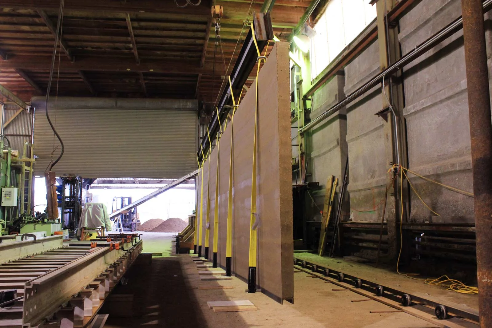 Measuring five feet high by twenty-four feet long, each of the 3” thick panels weighs 4,200 pounds when fresh out of the mold - 3,850 once the hydration water is converted. What keeps them together? Ultra high compression.