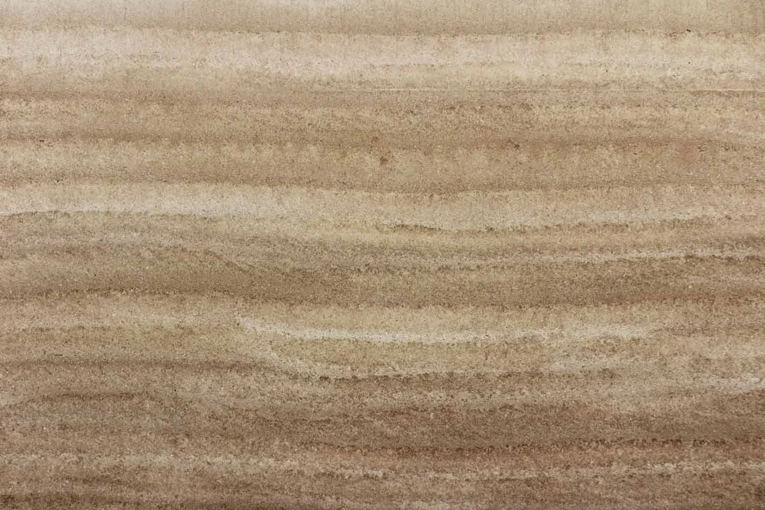 This close up of a panel shows the texture that can be achieved by varying lift depth and compaction energy. It is especially pronounced here while the wall still retains some of its casting moisture. The taller the lift, the greater the change in density from bottom to top. Look closely and you can see the chatter marks of the ramming tool itself.