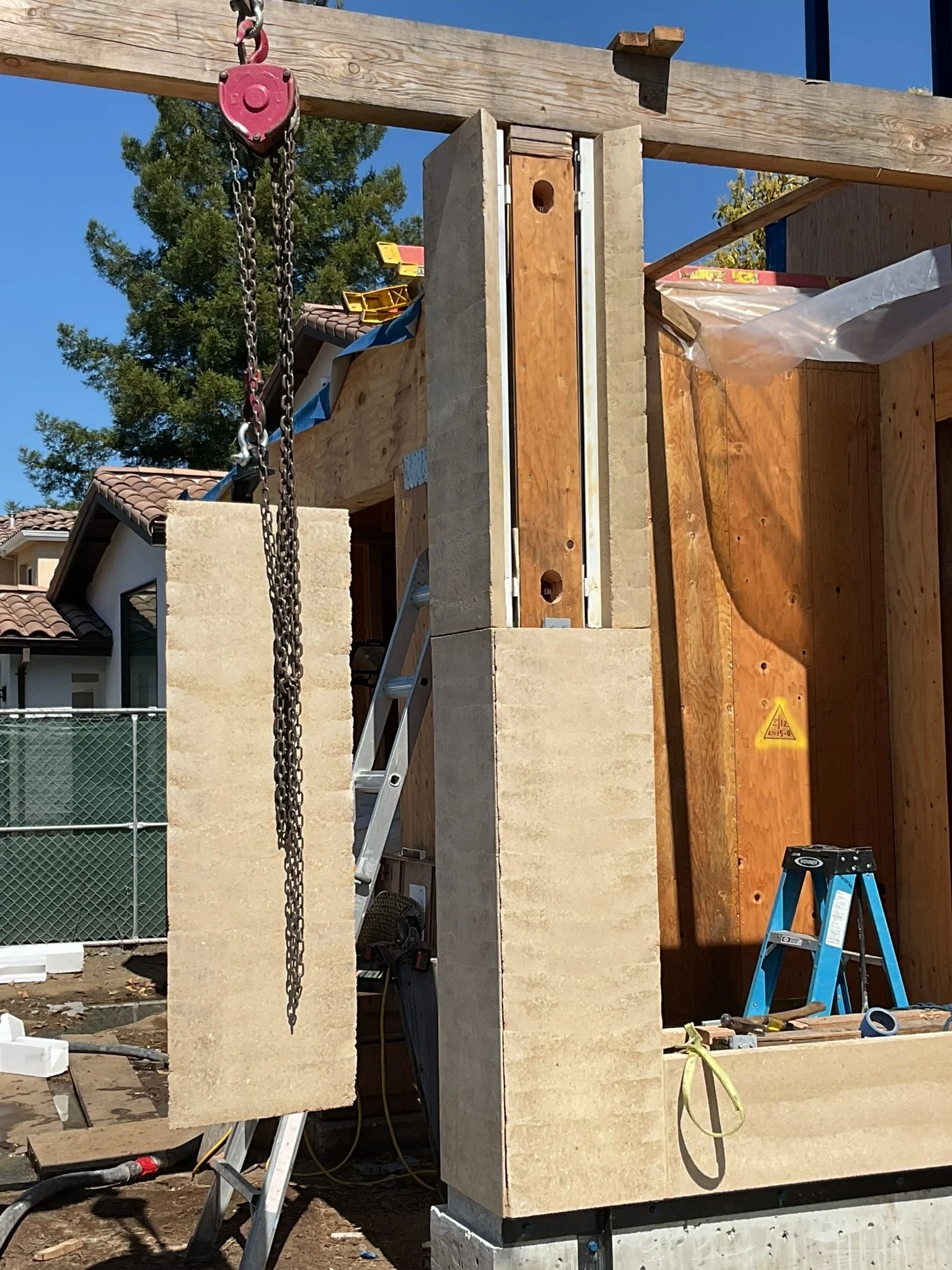  Here's a sneak peek mid-install of the panelized column in the entry way area. Stacking two panels high and four panels around, these mitered corners were important to get lined up.  