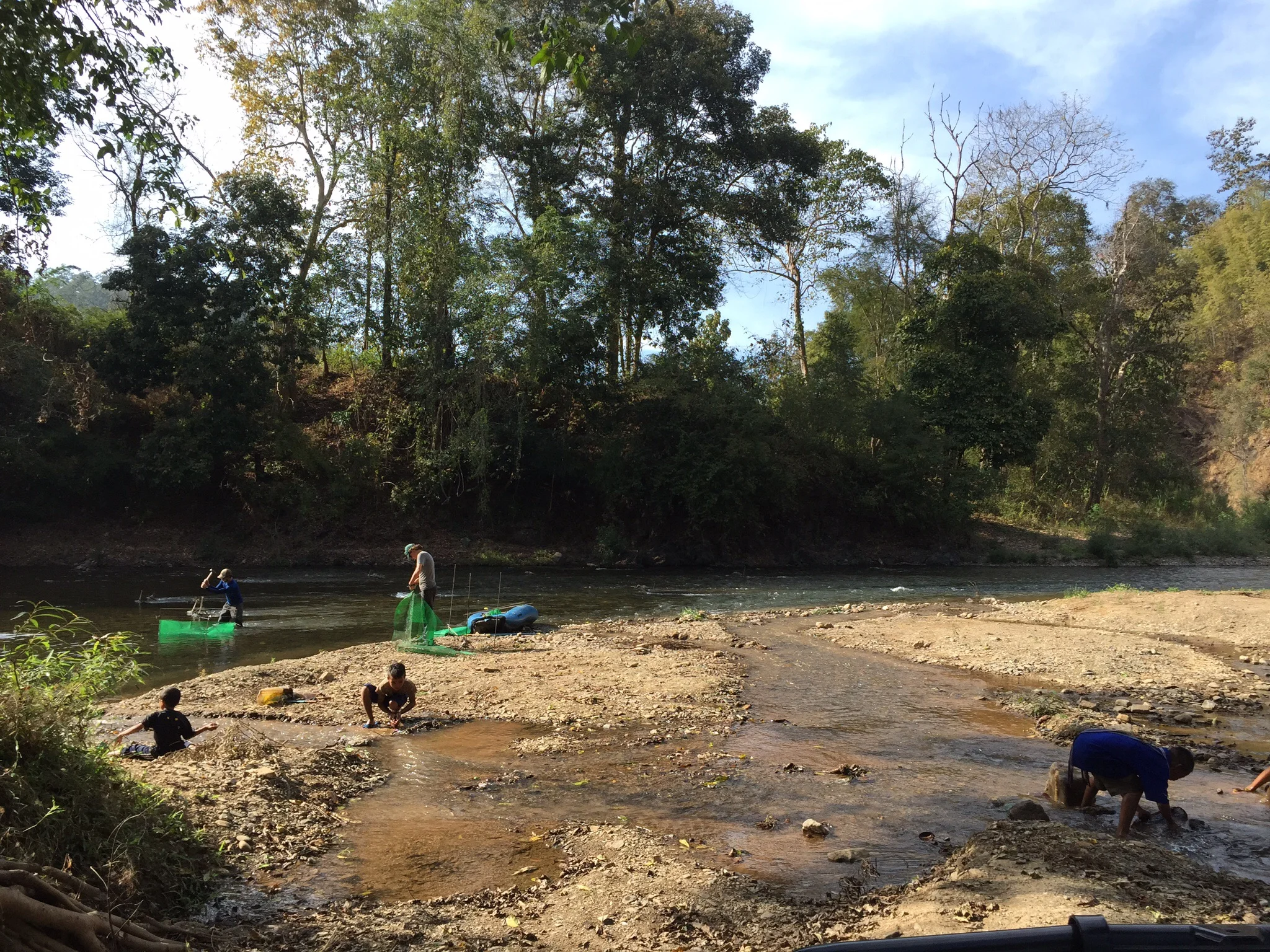 Last site of the day. Aaron pounds in exclosure 23 of 24, Hannah wraps 24 in plastic, and some local boys place fish nets and traps. Photo credit: Vera Swanson