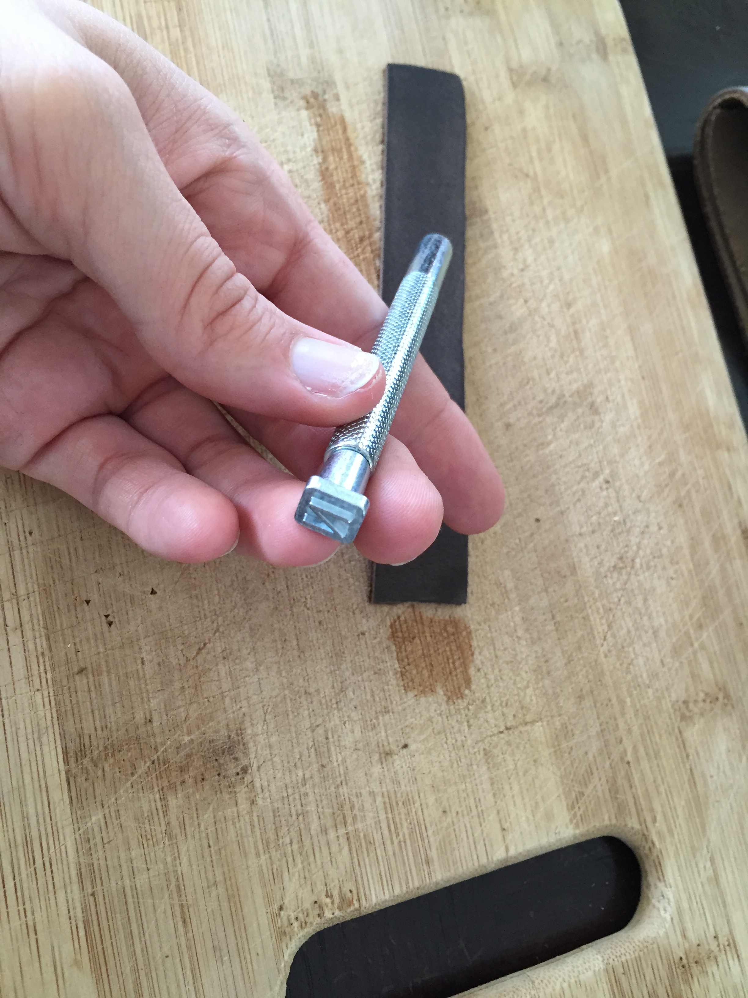 Load the first letter onto the stamping tool. Or, rather, the last letter. I started at the end with the last letter of the name and worked backwards. 