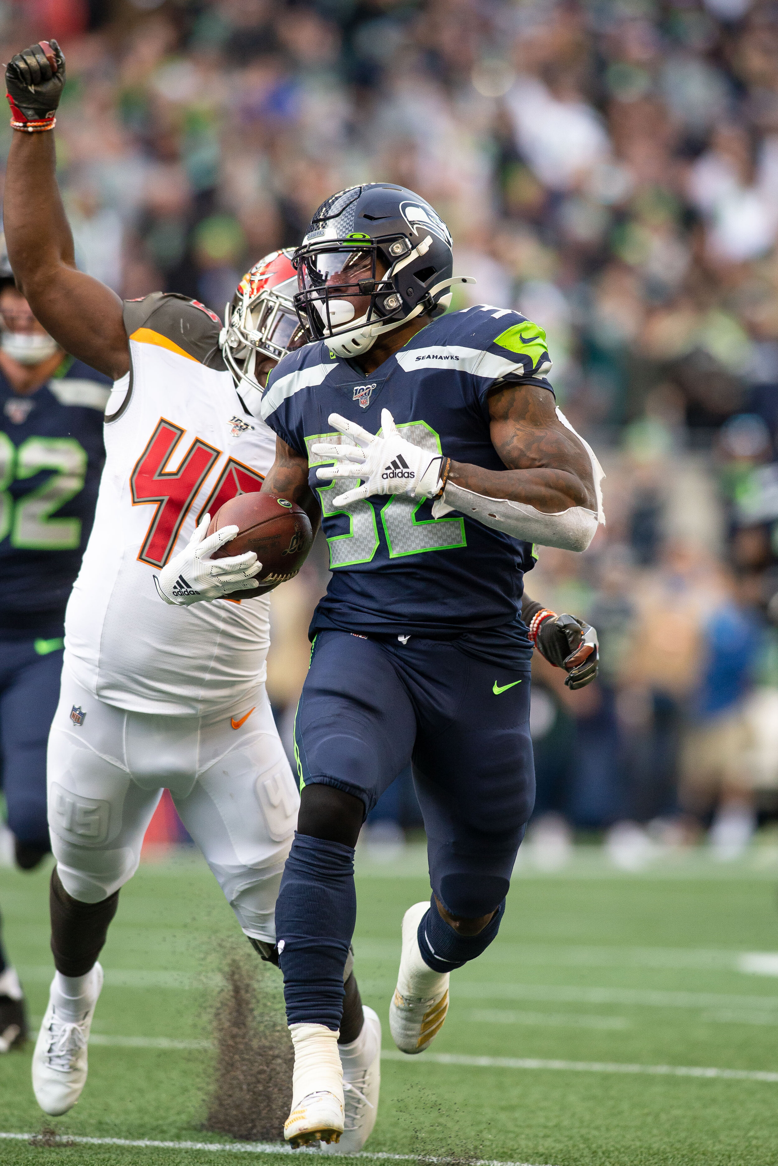  Seattle Seahawks running back Chris Carson (32) runs past Tampa Bay Buccaneers linebacker Devin White (45)  for a 59 yard gain during the third quarter of an NFL football game against the Tampa Bay Buccaneers, Sunday, Nov. 3, 2019, in Seattle. Seatt