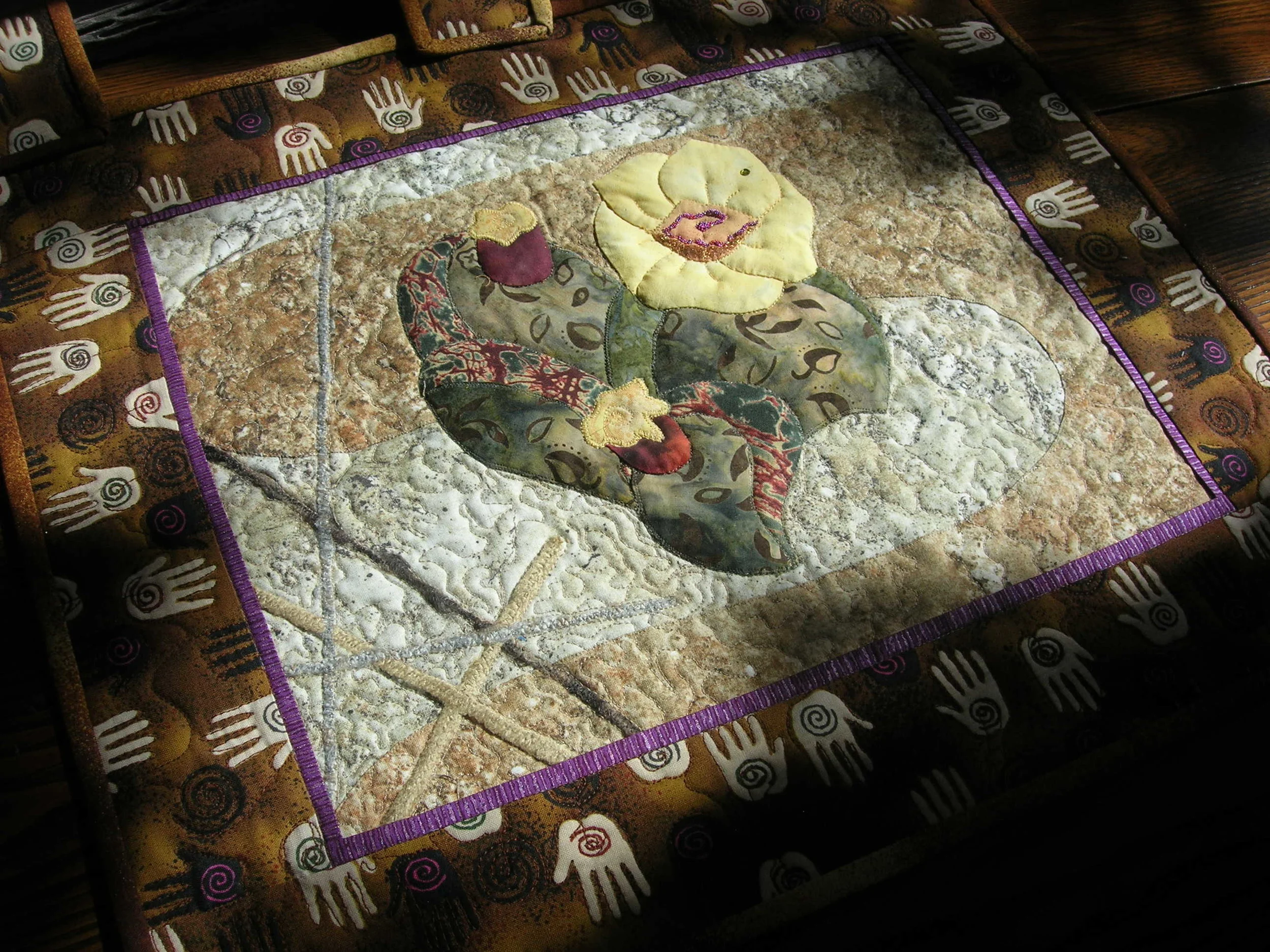  This particular theme has been reproduced both in my quilts and in my paintings. I took a picture of a particularly beautiful cactus and put it on purses, quilts, pallet knife and regular oil paintings. I made two of these at the same time and they 