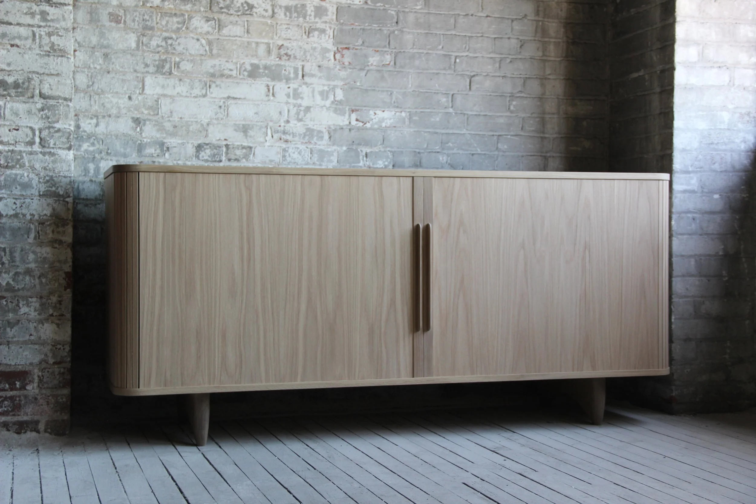  Tambour door credenza in white oak, with tinted lacquer drawer fronts 