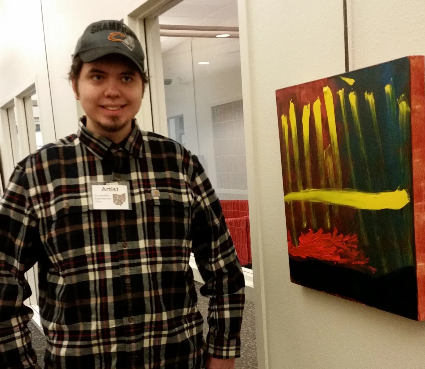 Jesse proudly poses beside his painting "Jesse's Comet" (first place winner in the Professional Artist Category)