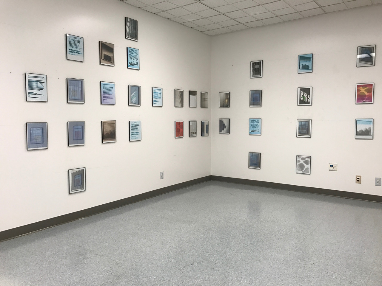 Amy Cella. Installation view of Search and Destroy, Just Be Careful in the Corner and You Move Fast, I Count Slow, 2017. Inkjet prints in 33 black plastic frames.