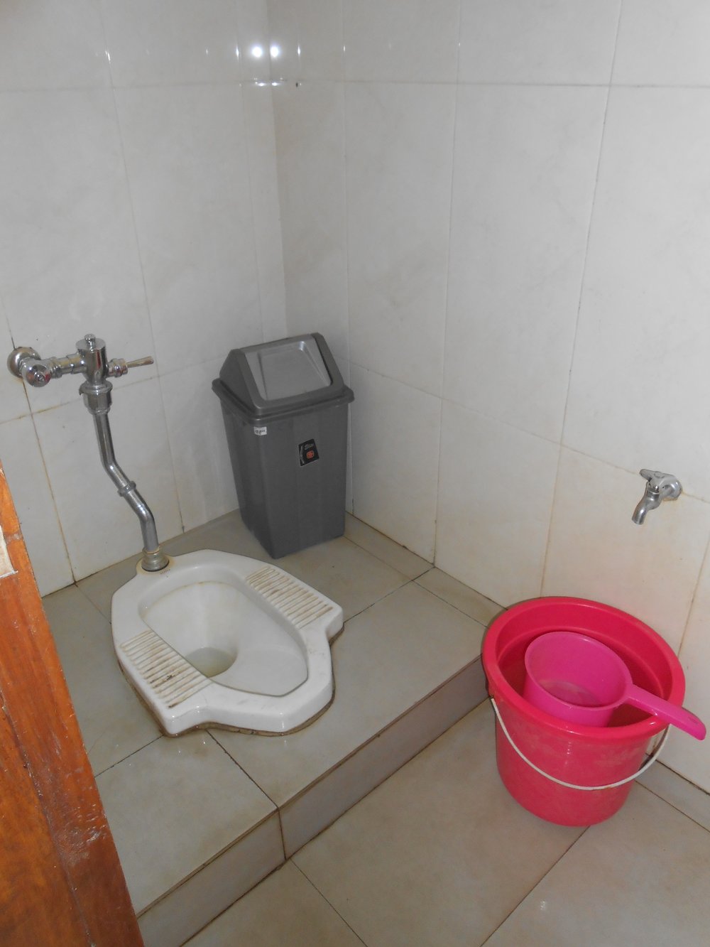   Indonesia squat toilet with water bucket  
