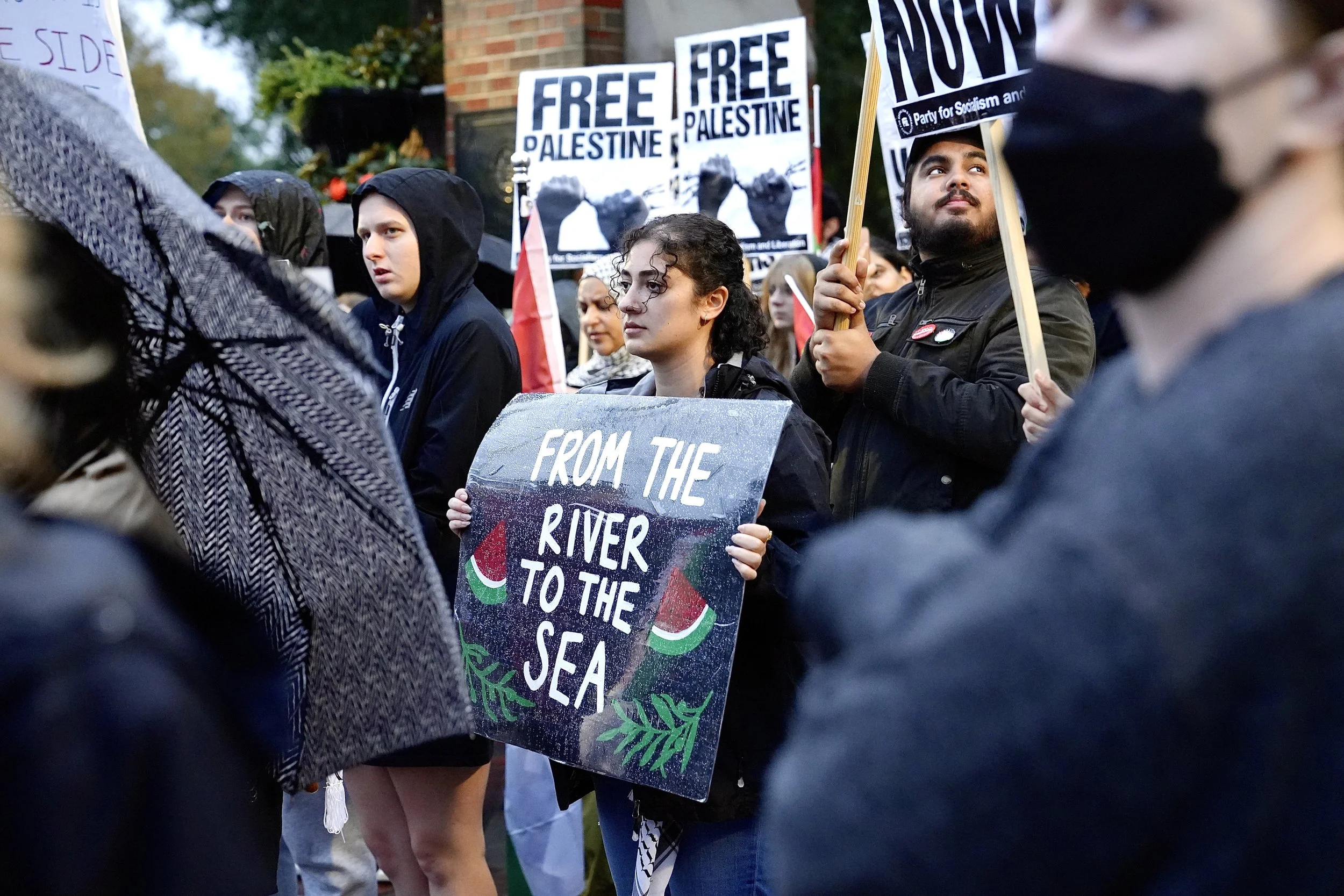 Protester holding a sign that says “From the River to the Sea” on the corner University Avenue and 13th Street in Gainesville in support of Palestine on Thursday, Nov. 16, 2023.