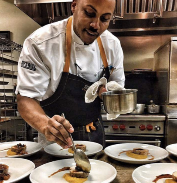 Chef Streete plating his Jerk Chicken with Plantain Dish