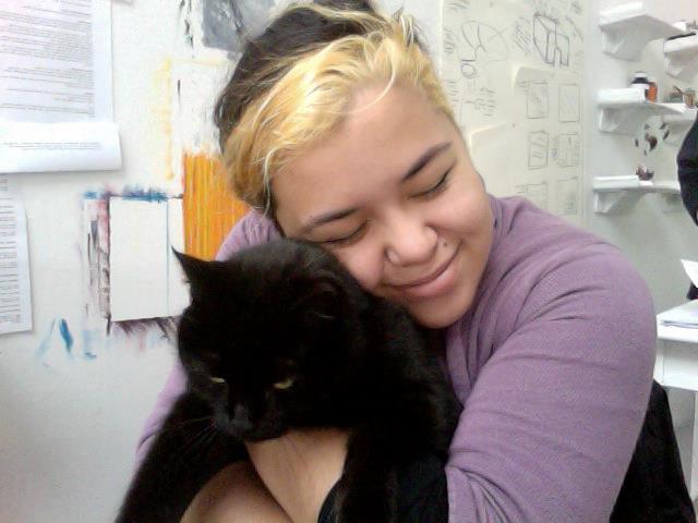 The campus cat and I, sitting behind my studio table. This cat really did love me. Rona's half of our shared wall begins behind me.