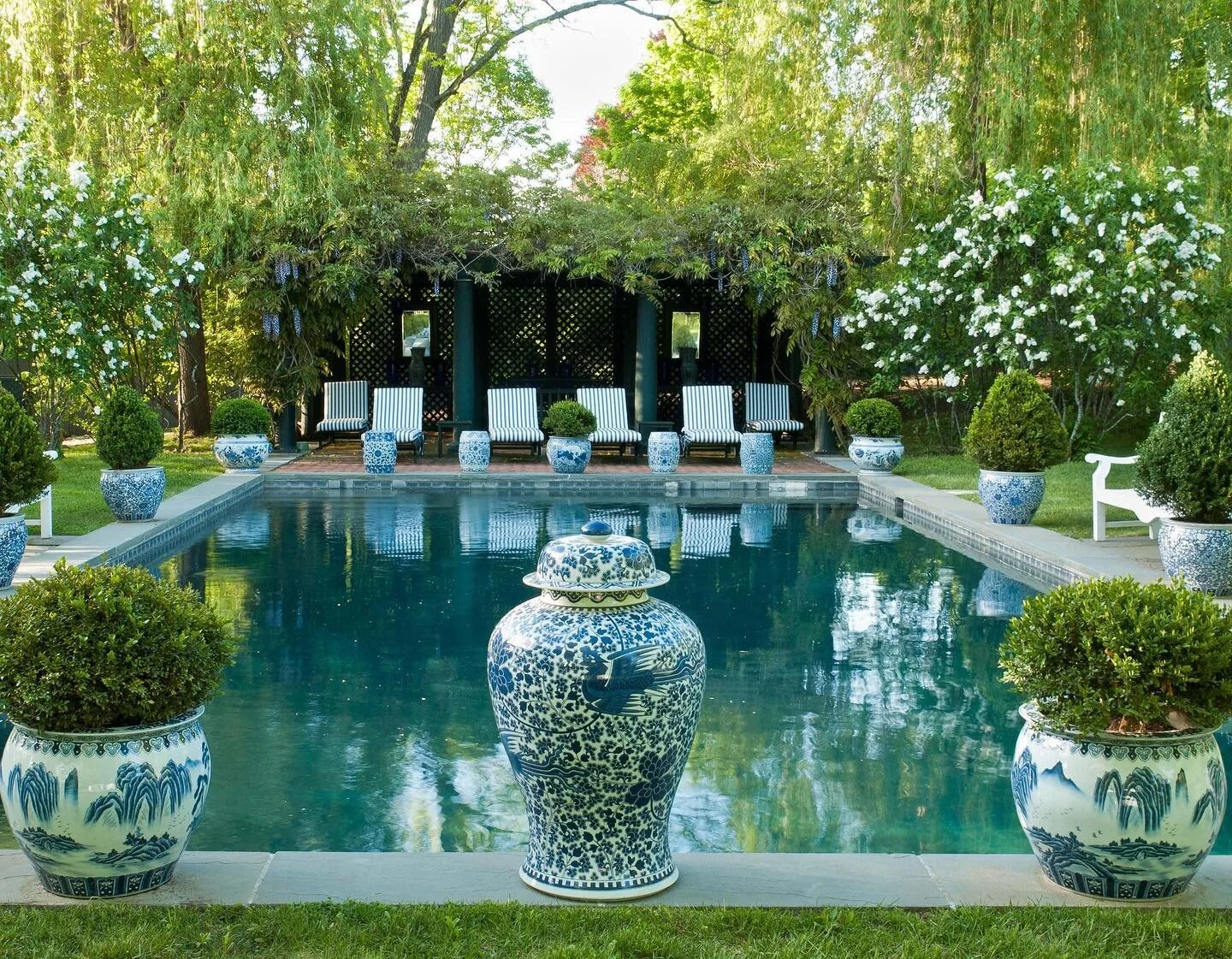I never get tired of seeing this pool by @carolyneroehm. Working on finishing touches in our backyard and there will be lots of blue and white...and of course boxwoods.