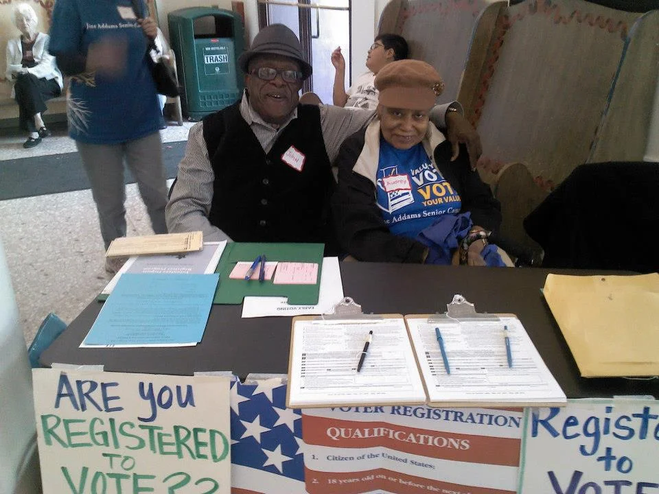 JASC leaders John and Audrey lead a voter registration table.