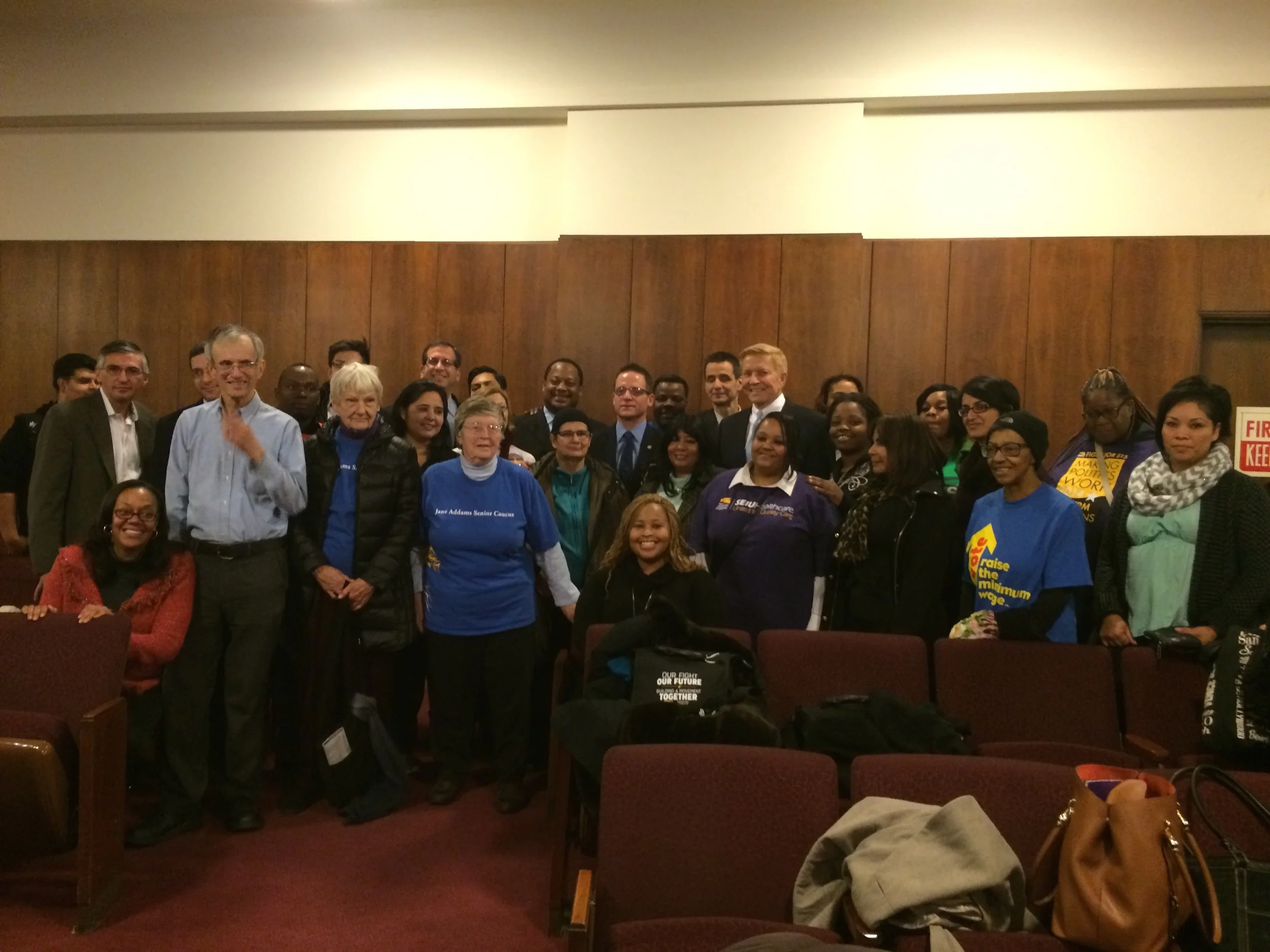 Leaders, aldermen, and staff posing for a celebratory picture after the $13 dollar ordinance was passed. 