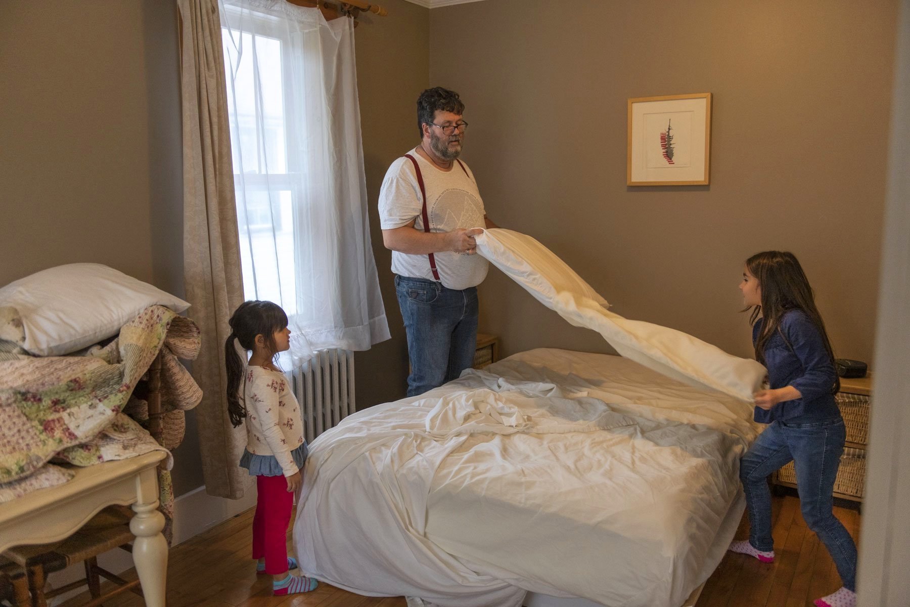  Serge Paradis and his daughters clean up a guest room at their bed and breakfast in the mining village of Bourlamaque. The bed and breakfast was originally a pension home that welcomed single workers from Europe to work at the mine. Today, patrons a