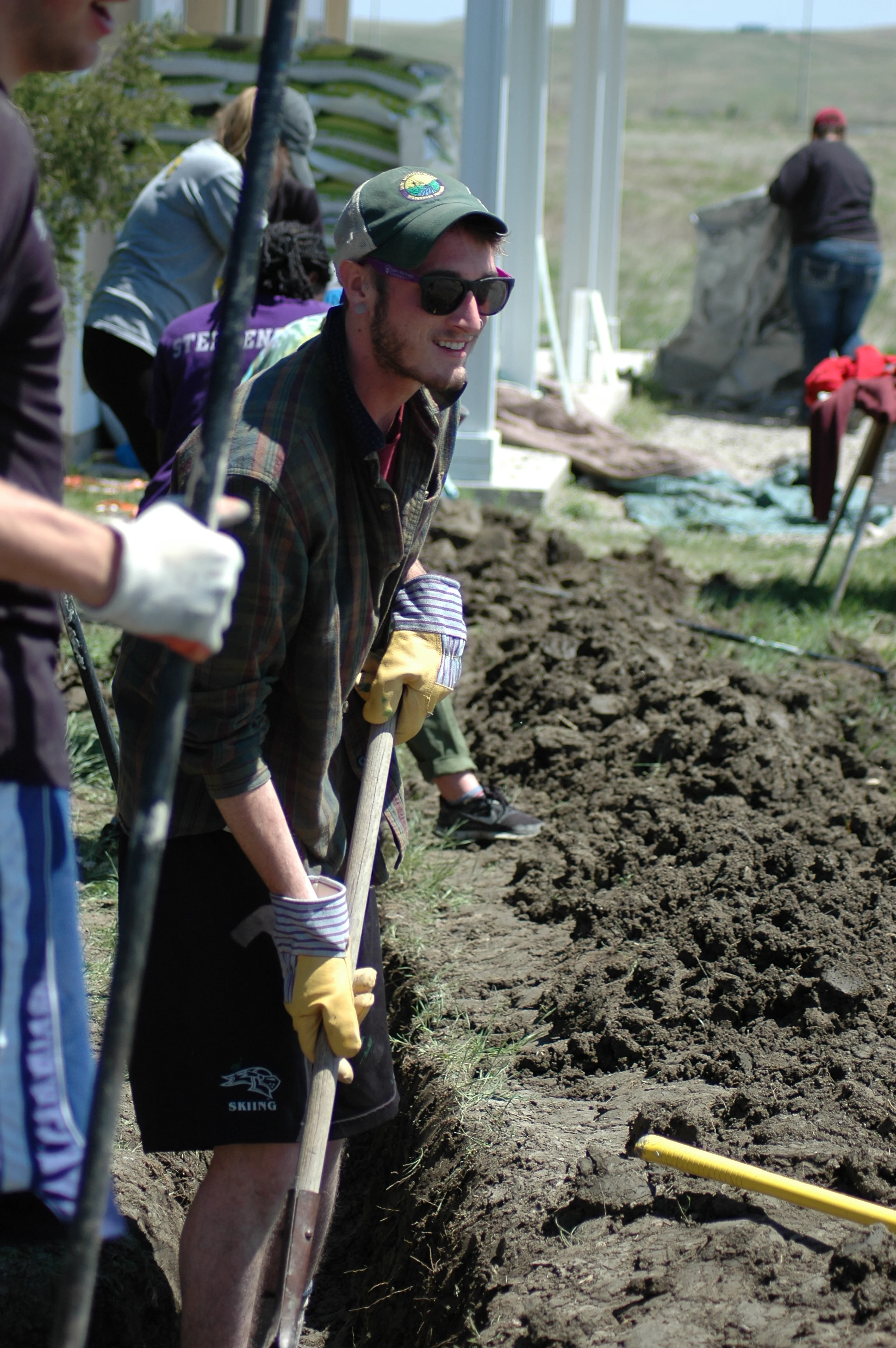 Ben, digging in to create a trench for the electrical and water lines at the new home. (A.Gross, La Plant, May 2015)