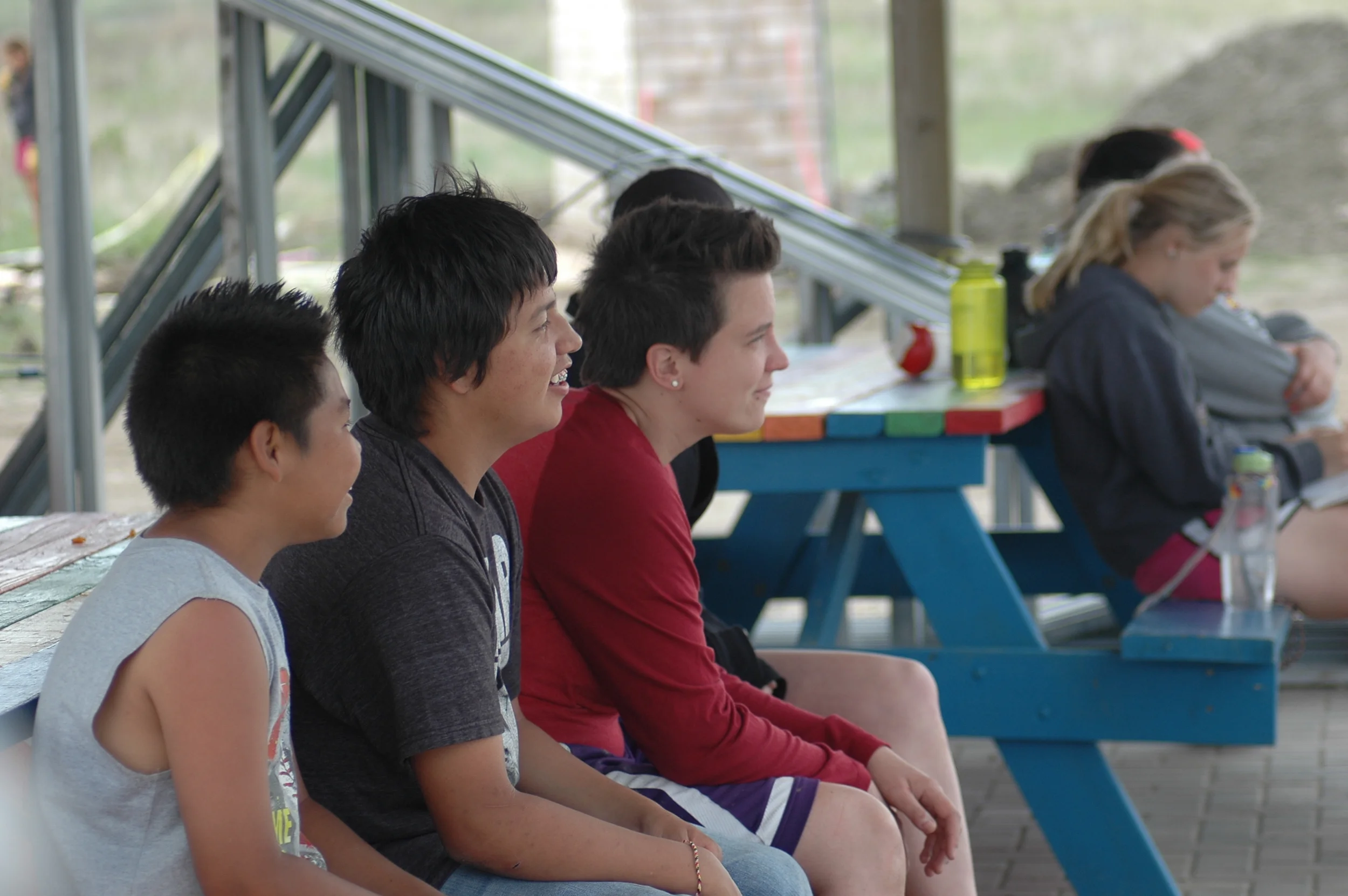 The kids and group watch on as a game of Knock Out is played on the new basketball court. (A.Gross, May 2015, La Plant)
