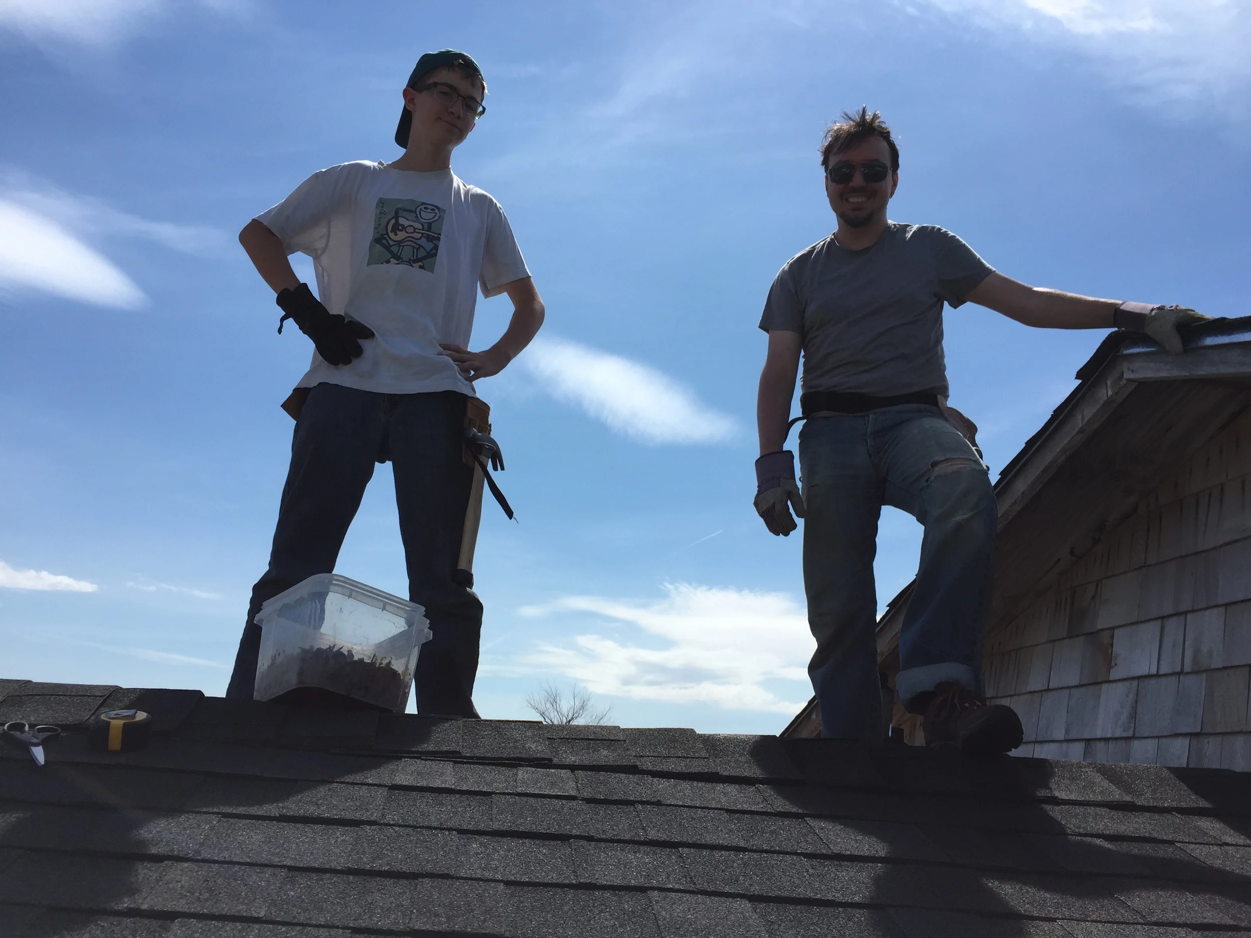 Calvin and Stefan became expert roofers as they shingled a part of the community center roof that was damaged by high winds. (Z. Gross, June 2015)