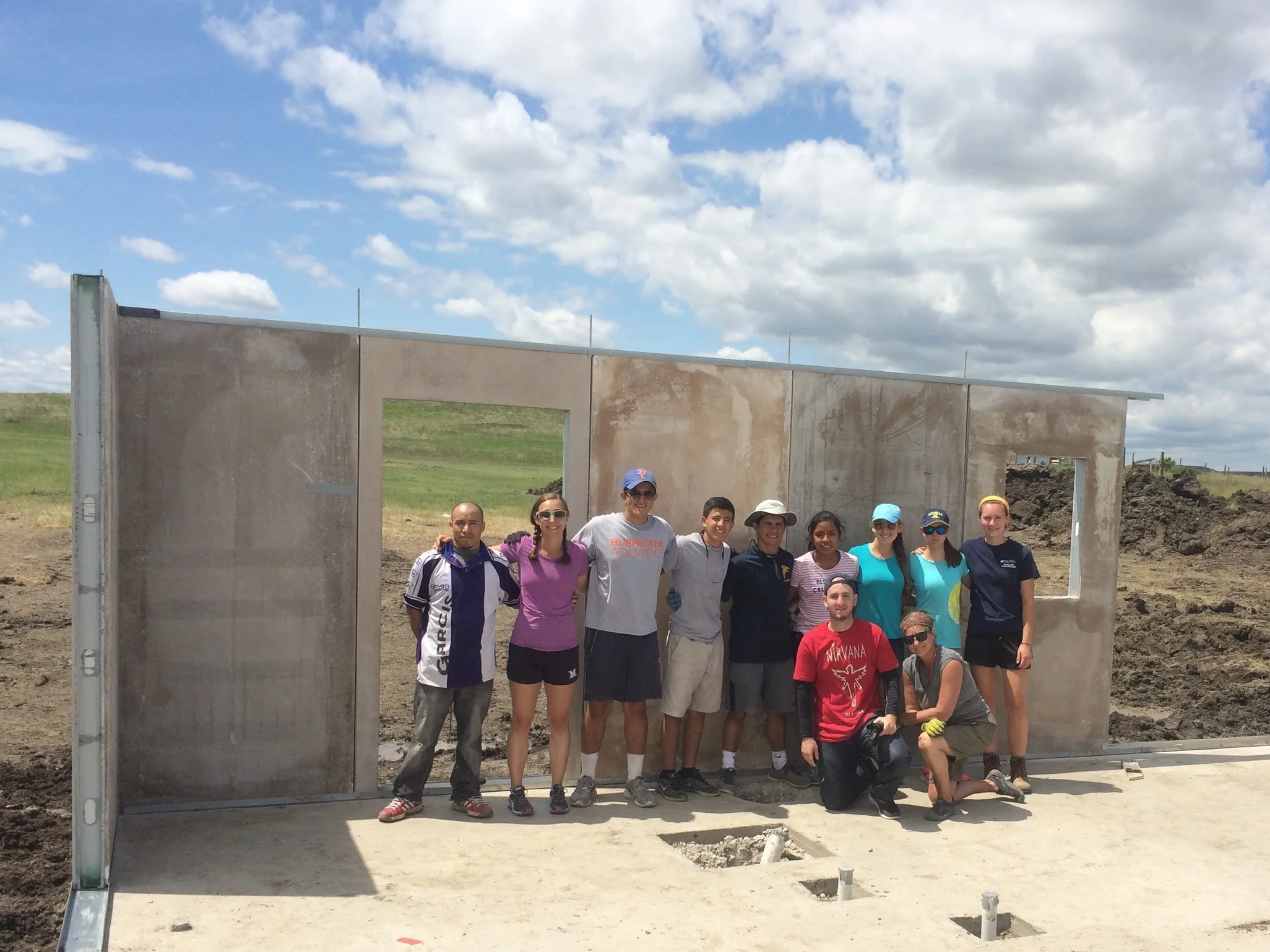 Many hands: The Palmer Trinity School crew helped to install six wall panels on a new home for a great family in La Plant!