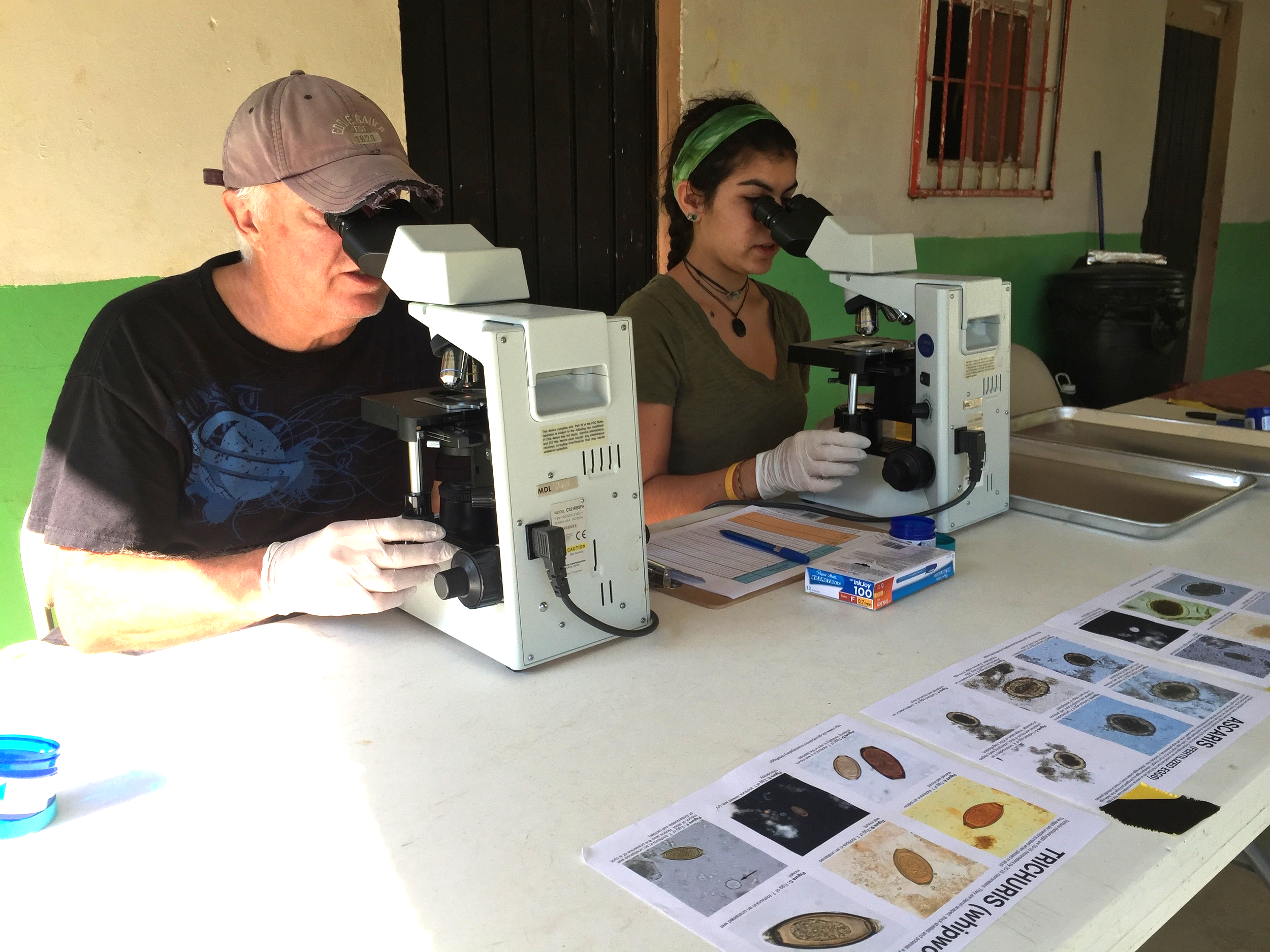 Erin, right, works alongside Simply Smiles board member and epidemiologist Dr. Gil L'italien to test stool samples for the presence of parasitic intestinal worms in Santa Maria Tepexipana and its neighboring communities.