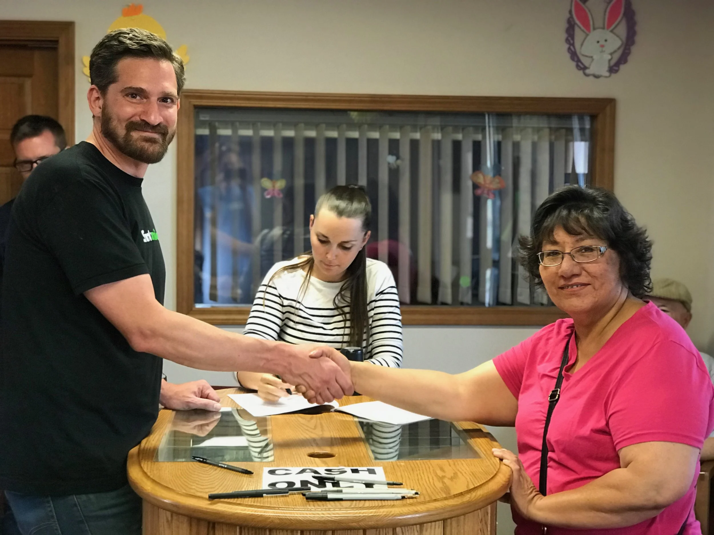 Deepening partnerships: Bryan Nurnberger (left), Simply Smiles President and Founder and Toni Buffalo (right), Administrator of the Dakota Association of the United Church of Christ sign the 99-year lease agreement, allowing Simply Smiles to continue and expand its programming on the Cheyenne River Sioux Tribe Reservation in South Dakota.
