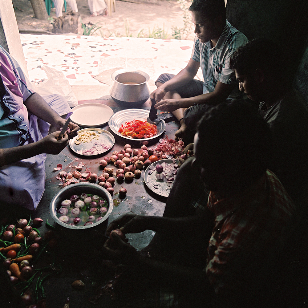   A group of people, including several kothis prepare food at Sivagami’s house. For many of the kothis, who live with their families, being able to prepare and serve food – considered to be “women’s work” is a way for them to express part of their fe