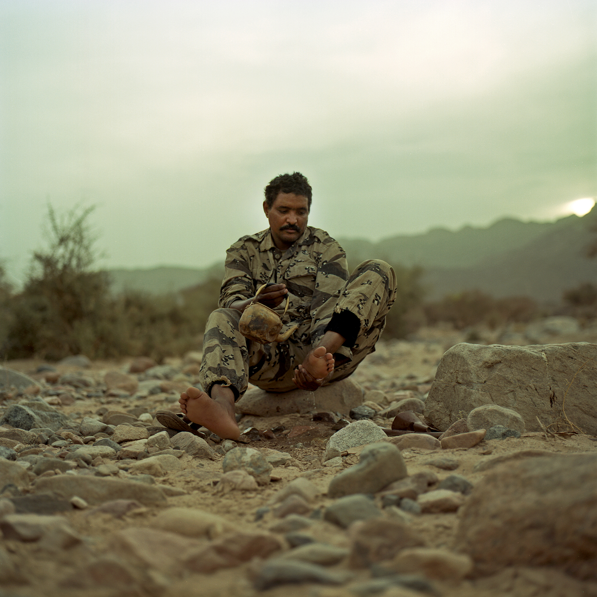 Amoumen Khalil washes his feet in preparation to pray. Amoumen, a trained veterinary technician who joined the rebellion after what he saw as decades of discrimination against Tuareg.