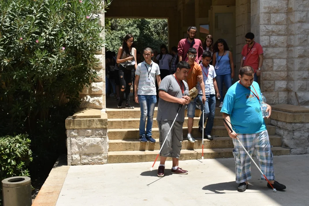 Visually impaired participants and volunteers descending stairs during O&M lesson
