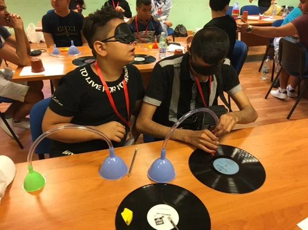 Visually impaired participants preparing their own record players during science class