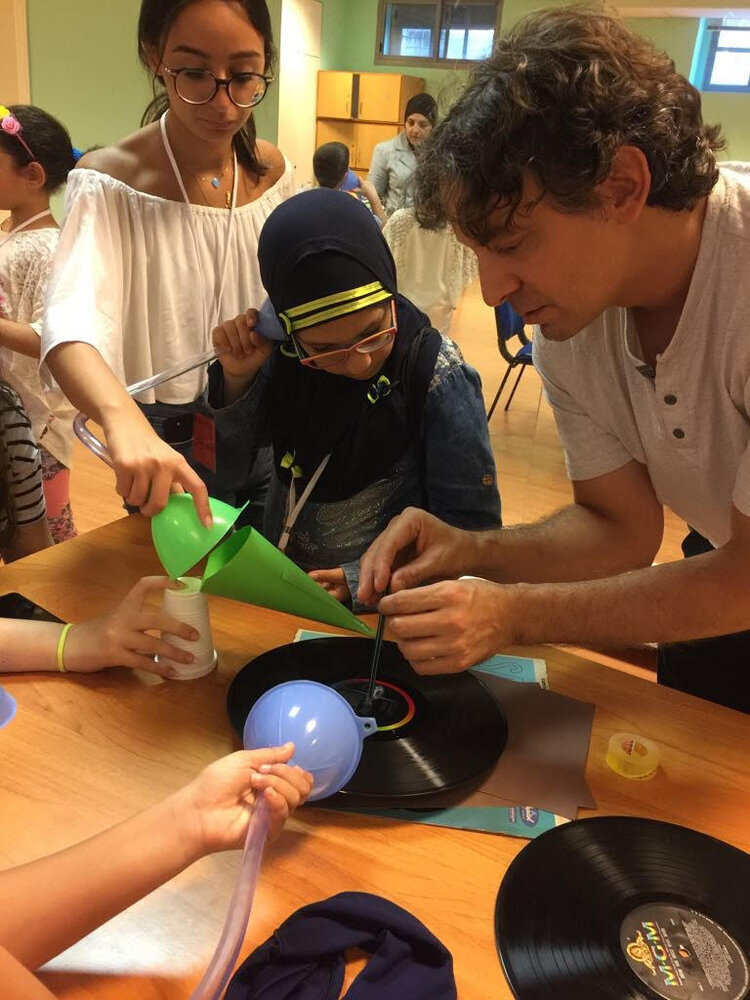 Children doing experiments with a volunteer