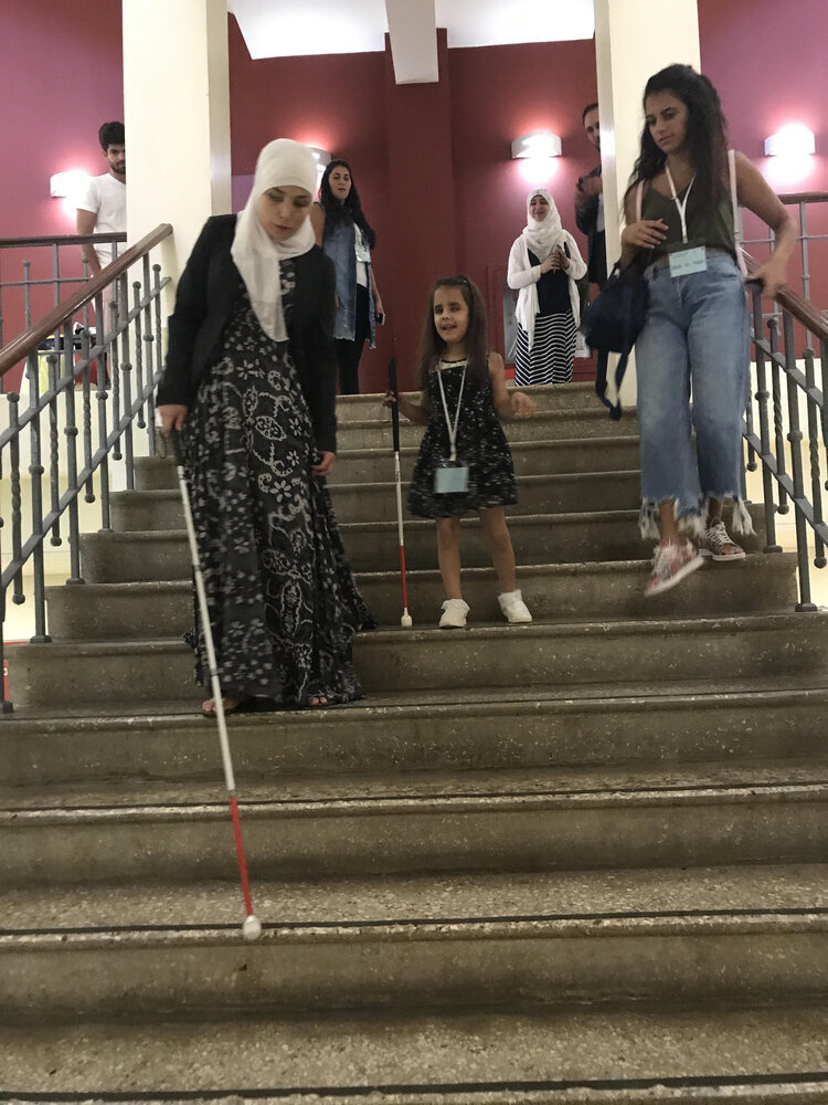 children and volunteers taking stairs together