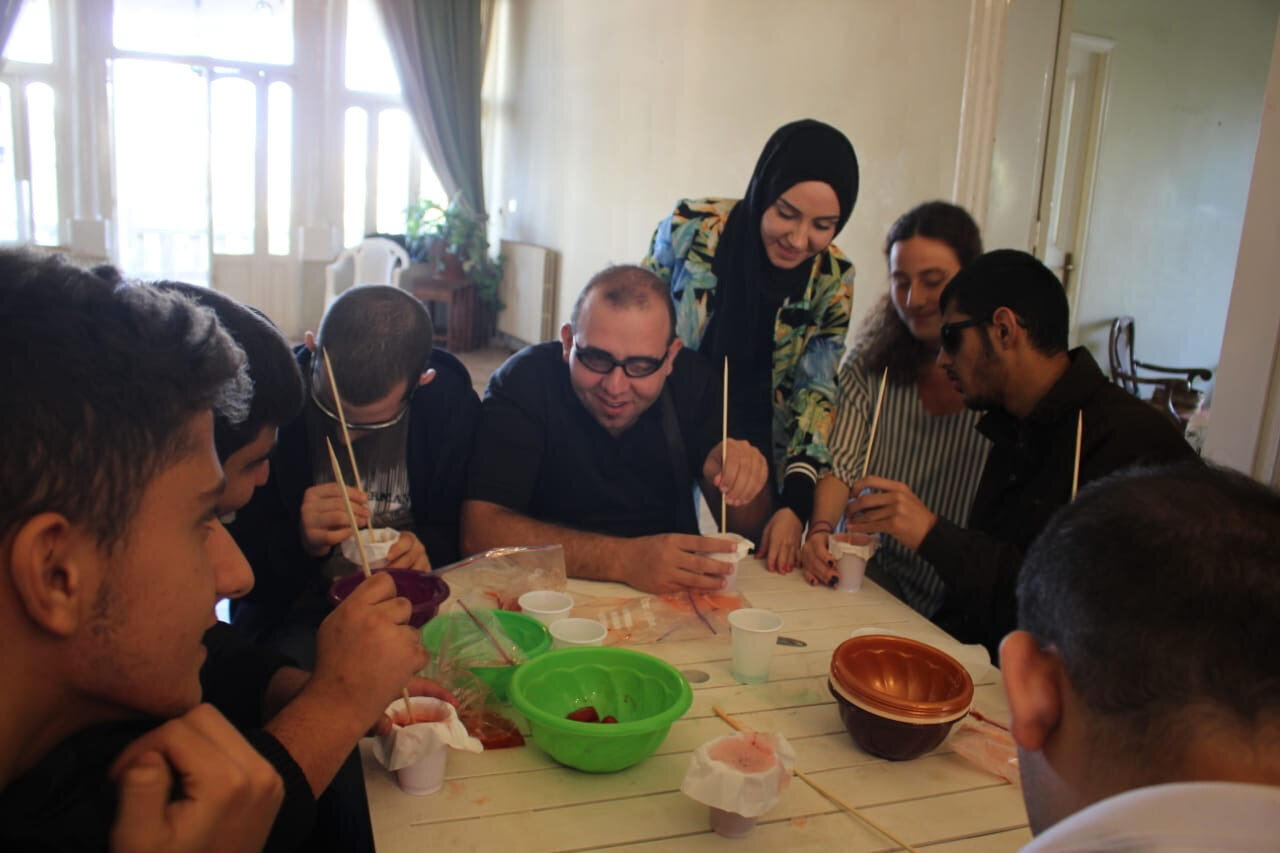 children collaborating with volunteers while doing experiments