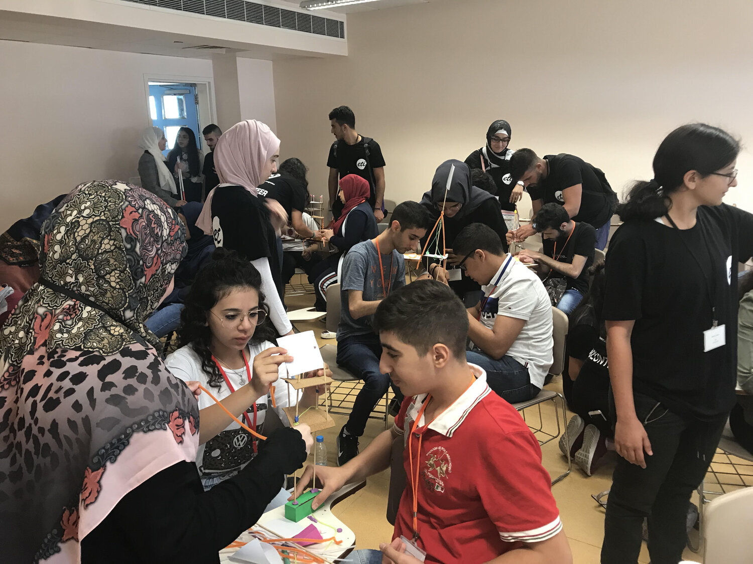 children working with volunteers to do experiments