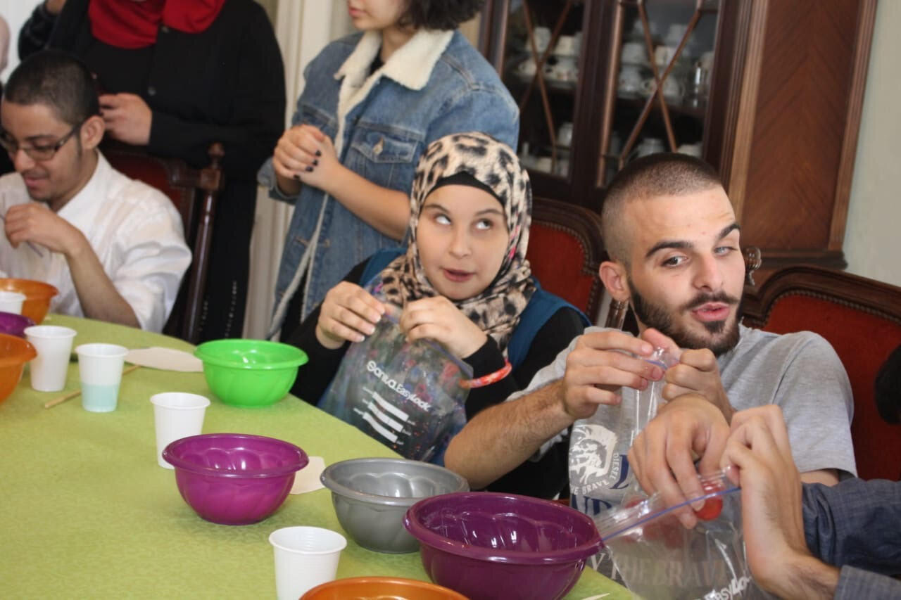 children working with volunteers while doing experiments