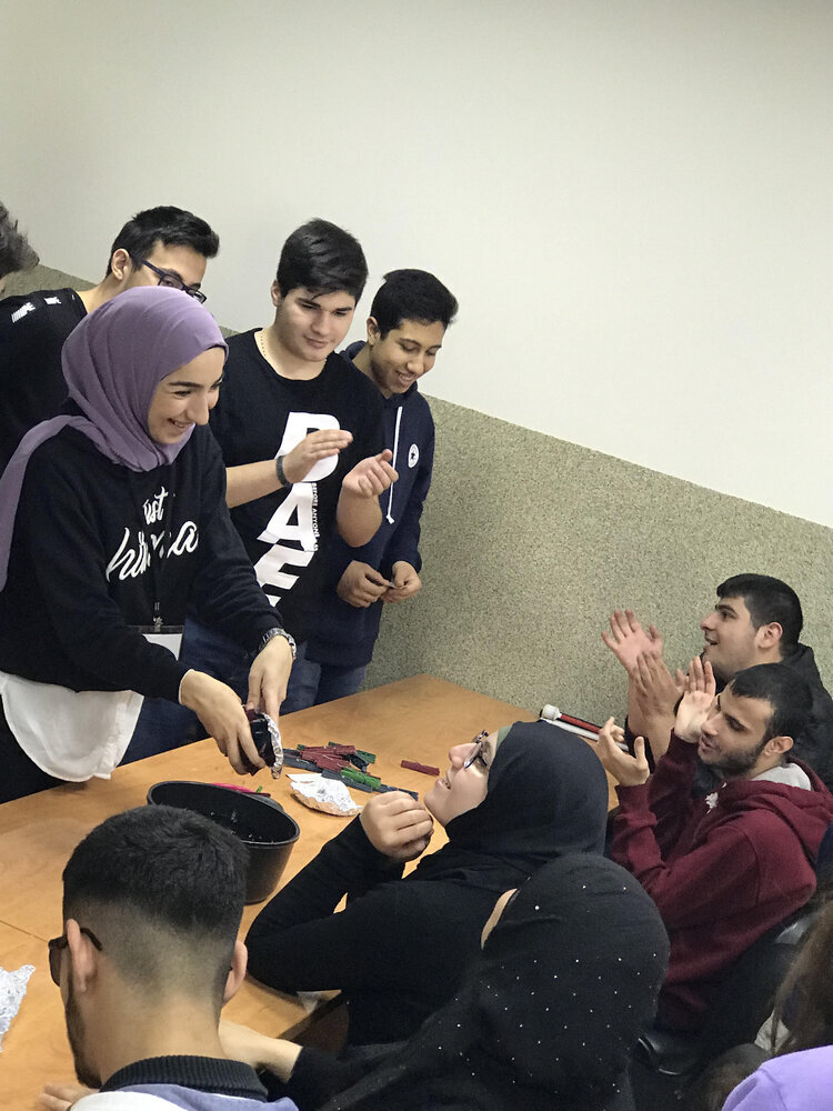 Children and volunteers doing experiments together